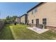 Large backyard with green grass, patio furniture, and fencing for privacy at 11910 Brightside Pkwy, Hampton, GA 30228