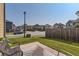 View of fenced backyard with grass, patio, chair and neighboring houses at 11910 Brightside Pkwy, Hampton, GA 30228
