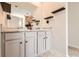 Elegant bathroom with double sink vanity, granite counters, and decor shelves at 11910 Brightside Pkwy, Hampton, GA 30228