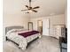 Comfortable bedroom with plush carpeting, ceiling fan, and double closets at 11910 Brightside Pkwy, Hampton, GA 30228
