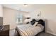 Comfortable bedroom features a plush bed, neutral walls, and ample natural light from the window at 11910 Brightside Pkwy, Hampton, GA 30228