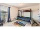 A bedroom has a bunk bed, cute chairs, carpet, and a playful rug at 11910 Brightside Pkwy, Hampton, GA 30228