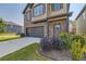 Charming two-story home with a well-kept lawn, featuring a two-car garage and landscaped shrubbery at 11910 Brightside Pkwy, Hampton, GA 30228