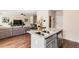 Open-concept kitchen with stainless steel appliances, granite countertops, and view to the living room at 11910 Brightside Pkwy, Hampton, GA 30228