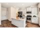 Modern kitchen with stainless steel appliances, granite countertops, and a functional island for cooking and entertaining at 11910 Brightside Pkwy, Hampton, GA 30228