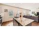 Stylish kitchen island featuring granite countertop, stainless steel dishwasher, and eat-in kitchen at 11910 Brightside Pkwy, Hampton, GA 30228