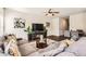 Spacious living room with a cozy sectional, hardwood floors, and a clear view to the adjacent dining area at 11910 Brightside Pkwy, Hampton, GA 30228