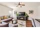 Comfortable living room with stylish decor, featuring a large sectional sofa, modern entertainment center, and ample lighting at 11910 Brightside Pkwy, Hampton, GA 30228
