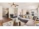 Bright living space with hardwood floors, comfortable seating, and a view into the modern kitchen area at 11910 Brightside Pkwy, Hampton, GA 30228