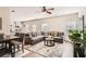 Open-concept living room with modern furnishings, a cozy sectional, and seamless flow to the kitchen at 11910 Brightside Pkwy, Hampton, GA 30228