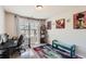 Bright home office with large window, desk, shelving, and vibrant rug at 11910 Brightside Pkwy, Hampton, GA 30228