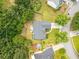 Aerial view of the home showcasing its landscaped lot, mature trees, and surrounding neighborhood at 1865 Morgans Run Trl, Buford, GA 30519