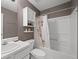 Bathroom featuring a shower-tub, toilet, vanity, and storage cabinet at 1865 Morgans Run Trl, Buford, GA 30519