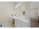 Well-lit bathroom vanity with double sinks, ample counter space, and a large mirror at 1865 Morgans Run Trl, Buford, GA 30519