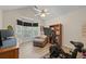 Bedroom boasting a ceiling fan, bay window, and a stationary bicycle at 1865 Morgans Run Trl, Buford, GA 30519