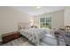 Cozy bedroom with light-filled window, stylish rug, and a trunk at 1865 Morgans Run Trl, Buford, GA 30519