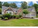 Charming single-story home features a brick facade, well-manicured lawn, and mature trees at 1865 Morgans Run Trl, Buford, GA 30519