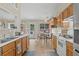 Well-lit kitchen featuring modern appliances and wooden cabinets, along with backyard views at 1865 Morgans Run Trl, Buford, GA 30519