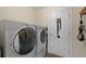 Convenient laundry room featuring modern washer and dryer units, maximizing functionality at 1865 Morgans Run Trl, Buford, GA 30519