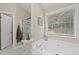 Relaxing main bathroom with a large soaking tub, a separate shower, and ample counter space at 1865 Morgans Run Trl, Buford, GA 30519