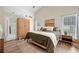 Spacious main bedroom with vaulted ceilings, wood floors, ensuite bathroom, and natural light at 1865 Morgans Run Trl, Buford, GA 30519