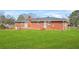 Large backyard with a well-maintained lawn and a brick house at 2649 Lake Harbin Rd, Morrow, GA 30260