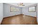 Bright bedroom features hardwood floors, neutral walls, and two windows providing ample natural light at 2649 Lake Harbin Rd, Morrow, GA 30260