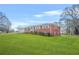Well-maintained red brick home with attached garage and lush green yard at 2649 Lake Harbin Rd, Morrow, GA 30260