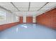 Spacious garage with brick accents, epoxy floor, and ample lighting at 2649 Lake Harbin Rd, Morrow, GA 30260