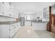 Bright kitchen featuring white cabinets, granite countertops, stainless steel appliances, and tile floors at 2649 Lake Harbin Rd, Morrow, GA 30260