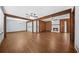 Spacious living room featuring hardwood floors, wooden beams and a cozy stone fireplace at 2649 Lake Harbin Rd, Morrow, GA 30260