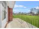 Outdoor patio area with railing overlooking a lush green lawn at 2649 Lake Harbin Rd, Morrow, GA 30260
