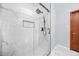 Contemporary shower stall with rainfall showerhead and sleek black hardware against marble-patterned walls at 2649 Lake Harbin Rd, Morrow, GA 30260