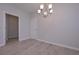 Bright dining room with modern chandelier, light wood floors, and neutral paint colors at 48 Beaver Pt, Villa Rica, GA 30180