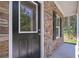 Close-up of the front door featuring stone accents and a view of the home's surroundings at 48 Beaver Pt, Villa Rica, GA 30180