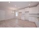 Bright, open kitchen and dining area featuring white cabinets, stainless appliances, and modern finishes at 48 Beaver Pt, Villa Rica, GA 30180