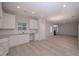 Spacious kitchen with stainless appliances, white cabinets, and modern light fixtures and an open floor plan at 48 Beaver Pt, Villa Rica, GA 30180