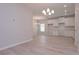 Open-concept kitchen and dining area with stainless steel appliances and modern light fixture at 48 Beaver Pt, Villa Rica, GA 30180