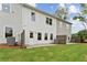 Back exterior of home with an outdoor patio and green lawn on a sunny day at 105 Priestwood Ln, Acworth, GA 30102
