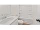 Bright bathroom featuring a shower-tub combo, toilet, and single sink vanity with chrome faucet at 105 Priestwood Ln, Acworth, GA 30102