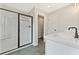 Modern bathroom with a glass-enclosed shower, white vanity, and dark fixtures and floor at 105 Priestwood Ln, Acworth, GA 30102