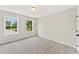 Light-filled bedroom with carpeted floors and two windows that provide nice light at 105 Priestwood Ln, Acworth, GA 30102
