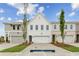 Attractive new townhomes featuring attached garages, varied exterior finishes, and professionally landscaped front yards at 105 Priestwood Ln, Acworth, GA 30102