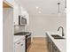 Modern white and dark gray kitchen featuring an island, stainless steel appliances, and pendant lighting at 105 Priestwood Ln, Acworth, GA 30102