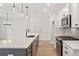 Modern kitchen featuring stainless steel appliances, hardwood floors, a large island, and pendant lights at 105 Priestwood Ln, Acworth, GA 30102