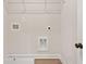 Well-lit laundry room equipped with washer hookups, a utility sink, and a wire shelf at 105 Priestwood Ln, Acworth, GA 30102