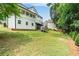 Expansive backyard with lush green grass and mature trees, offering plenty of space for outdoor activities at 340 Chandler Ct, Sugar Hill, GA 30518