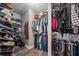 Walk in closet features wood flooring, shelving, and rods for hanging clothing at 340 Chandler Ct, Sugar Hill, GA 30518