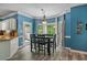 Inviting dining area with a bay window, modern light fixture, and hardwood floors at 340 Chandler Ct, Sugar Hill, GA 30518