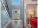 Inviting home foyer with a two-story ceiling, wood floors, grand staircase, and abundant natural light at 340 Chandler Ct, Sugar Hill, GA 30518